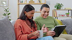 Love, couple with tablet and on sofa happy together in living room of their home together. Support or care, connectivity or social media and young married people streaming movie or series on couch