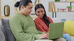 Laptop, sofa and happy couple search online, relax and talking, conversation or planning life together at home. Living room, typing and interracial woman and partner on computer, couch and internet