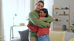 Love, couple hug and together in living room of their home for support or gratitude. Comfort or care, partnership or kindness and young married people hugging for trust or empathy in their house