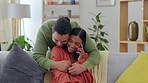 Love, phone call and man hugging his girlfriend while relaxing on a sofa in the living room. Happy, smile and young woman on a mobile conversation with her boyfriend embracing her from behind at home