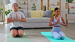 Yoga, fitness and couple in living room, praying and meditation, healing or holistic training at home. Calm, peace and people meditate, pilates and prayer hands or sign for zen class and wellness