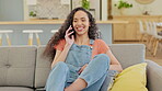 Online communication, woman on a phone call and on sofa in living room of her home for social networking. Connectivity or technology, relax or happy and female person talking on her smartphone 