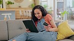 Home, ecommerce and woman with a tablet, credit card and online shopping with transactions, connection and happy. Female person, excited customer or girl on a sofa, technology or payment with banking