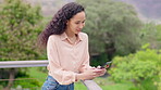 Woman typing, smartphone and chat outdoor, communication and social media while on balcony. Young female person, smile when writing email or text message, search internet and online with mobile app