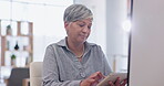 Technology, businesswoman with tablet and happy at her desk in a modern workplace office. Online communication, connectivity or social networking and elderly female person browsing the internet