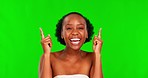 Green screen, face and black woman with skincare, pointing up or excited on a studio background. Portrait, female person or model with hand gesture, announcement and cosmetics with wellness or choice
