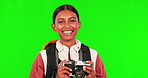 Hiking, photography and camera with a woman on green screen background in studio showing thumbs up while winking. Portrait, smile or wave with a young female hiker taking a photograph on chromakey