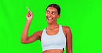 Indian woman, fitness and pointing at choice on green screen, workout decision and face on studio background. Comparison, wellness advertising and portrait, female person with options and information