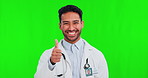 Thumbs up, success and doctor on green screen for healthcare, excellence in hospital or clinic services. Like and yes emoji, hands or sign with face of medical asian person on studio background