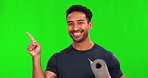 Pointing, green screen and man athlete with yoga mat showing sports deal isolated in a studio background. Smile approve and portrait of young male person with choice of health, exercise or fitness