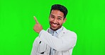 Pointing, doctor and Asian man with green screen, face and healthcare with announcement, promotion and choice on a studio background. Portrait, male person and medical professional with presentation