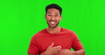 Comic, funny or laughter with a man on a green screen background in studio for humor or joking. Portrait, smile and comedy with a happy young asian male laughing at a meme on chromakey mockup