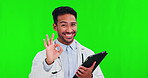 Okay sign, tablet and doctor on green screen for healthcare services. telehealth and professional advice. Like or yes emoji, happy face and medical asian person on digital tech and studio background