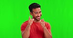 Green screen, yes and man face with hand pointing in studio for you, approval or vote on mockup background. Finger, agreement and portrait of happy asian male person with gesture, emoji or expression