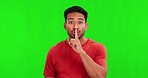 Face, green screen and man with finger, lips and silent with secret, gossip and  information against a studio background. Portrait, male person and model with hand gesture, stop noise and silence