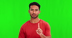 Warning, serious and face of an Asian man on a green screen with a no, stop or rejection. Refuse, negative and portrait of a person with a hand gesture for disapproval isolated on a studio background