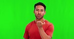 Face, man and blowing kiss on green screen, background and studio for love, care and flirting. Portrait, happy asian male model and air kissing with hands for romance, emoji and joy of valentines day