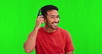 Green screen, listening and face of an Asian man with headphones for conversation, music or audio. Happy, response and portrait of a person or male dj streaming isolated on a studio background