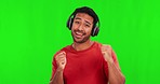 Man, dancing and headphones with face, green screen and happy for music, audio streaming and mock up. Young male student, excited and listening to radio, sound tech and smile in studio portrait