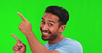 Happy asian man, hands and pointing up on green screen for marketing against a studio background. Portrait of male person face, smile and show for advertising, notification or news on mockup space