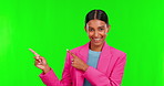 Presentation, product and pointing with a woman on green screen background in studio for advertising. Portrait, marketing or information of a happy young female brand ambassador on chromakey mockup