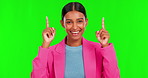 Happy woman, pointing up and green screen for advertising or marketing against a studio background. Portrait of female person with smile and show for news, notification or advertisement on mockup