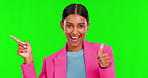 Pointing, product or thumbs up with a woman on green screen background in studio for advertising. Portrait, marketing and finger of a young female brand ambassador showing information on chromakey
