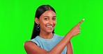 Green screen, pointing and face of indian woman, mockup space and advertising announcement in studio. Happy portrait, female model and yes to review, sign up promotion and good news for sales launch