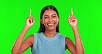 Happy woman, pointing up and green screen for advertising or sale against a studio background. Portrait of female person with smile, finger and show in news, notification or marketing on mockup space