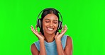 Happy woman, headphones and dancing to music on green screen against a studio background. Portrait of female person smile with headset listening for audio streaming, songs or sound track on mockup