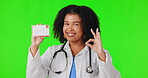 Okay, green screen or happy woman doctor with business card advertising healthcare infomation. Face portrait, good or nurse with hand gesture for approval, yes or like sign in studio for promotion