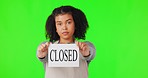 Green screen, woman face and closed sign in studio with economy crisis or disaster on mock background. Small business, fail and portrait of female employee with poster for bad news of inflation