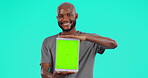 Black man, tablet and mockup on green screen for advertising or marketing against a studio background. Portrait of happy African male person show technology with chromakey display or tracking markers