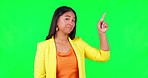 Green screen, woman and thinking face with hand pointing in studio for how to, steps or menu on mockup background. Portrait, offer and asian lady person showing checklist, timeline or promo info list