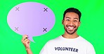 Asian man, speech bubble and volunteer on green screen for social media, chat or NGO against a studio background. Portrait of happy male person show shape icon for FAQ, voice or advertising on mockup