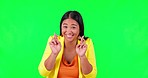 Fingers crossed, green screen and happy woman face in studio with good luck, sign and wish on mockup background. Smile, portrait and asian female with emoji hands for hope, optimism or suspense