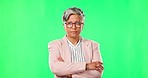 Arms crossed, face and a mature woman on a green screen for ceo career and serious management. Corporate, glasses and a portrait of an executive employee isolated on a mockup studio background