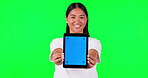 Tablet, advertising or marketing and a woman on green screen background in studio holding a display with tracking markers. Portrait, branding website and a happy young asian female holding chromakey