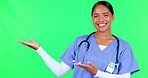 Marketing, pointing and doctor in a studio with green screen for a promotion or advertising. Healthcare, happy and portrait of a female nurse with a presentation hand gesture by chroma key background