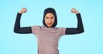 Face, exercise and Islamic woman with fitness, flexing arms and wellness against a blue studio background. Portrait, female person or Muslim model flex, strong and power with energy and workout goals