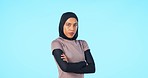 Face, arms crossed and muslim woman in studio isolated on a blue background mockup space. Islam, serious portrait and confident person from Saudi Arabia with stylish hijab, fashion and casual clothes