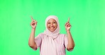 Marketing, pointing and muslim woman in a studio with green screen for advertising or promotion. Happy, smile and mature islamic female model with a presentation hand gesture by chroma key background