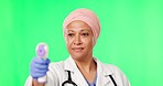 Doctor, woman and thermometer by green screen, face or check for healthcare, covid and mockup. Islamic female medic, temperature and medical technology for information for wellness by studio backdrop