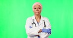 Green screen, woman and doctor with arms crossed, face or wellness against a studio background. Portrait, female person or medical professional with confidence, healthcare or innovation with research