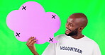 Speech bubble, volunteer and a black man on green screen in studio for social media communication. Portrait, charity or advertising and a male brand ambassador holding mockup with tracking markers