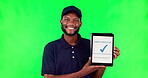 Tablet, logistics and complete with a black man on a green screen background in studio for distribution. Technology, supply chain delivery and order with a young male courier on chromakey mockup