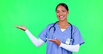 Advertising, pointing and nurse in a studio with green screen for a promotion or marketing. Healthcare, happy and portrait of a female doctor with a presentation hand gesture by chroma key background
