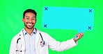Asian man, doctor and speech bubble on green screen for advertising against a studio background. Portrait of male person, medical or healthcare professional smile with shape for chat on mockup space