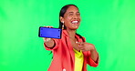 Business phone, woman pointing and green screen, presentation or advertising space for social media video. Funny, face and creative person on mobile app mockup, tracking markers and studio background