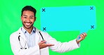 Asian man, doctor and pointing to speech bubble on green screen for advertising against a studio background. Portrait of male person, medical or healthcare show with shape for chat on mockup space
